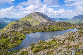 View from beside a tarn on the summit of Haystacks, looking out across the surrounding mountains